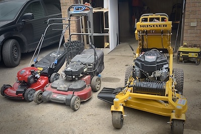 Lawn mowers being repaired at a house